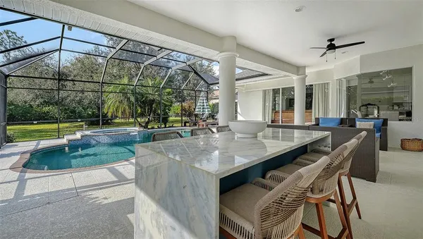 an open kitchen with granite countertop a table and chairs in it