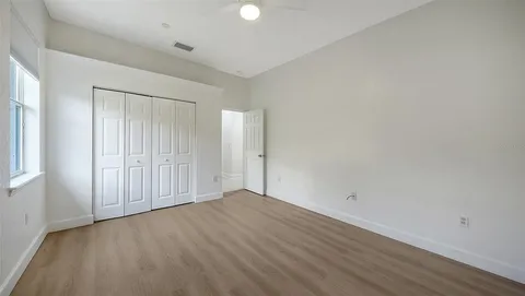 a view of an empty room with wooden floor
