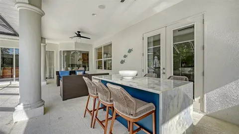 a view of a patio with a table chairs and a backyard