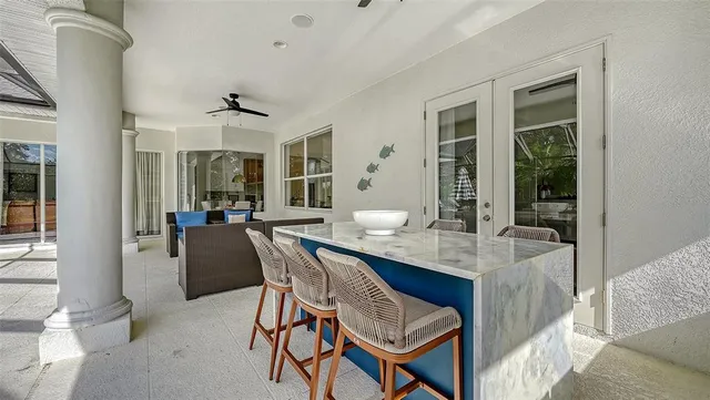 a view of a patio with a table chairs and a backyard