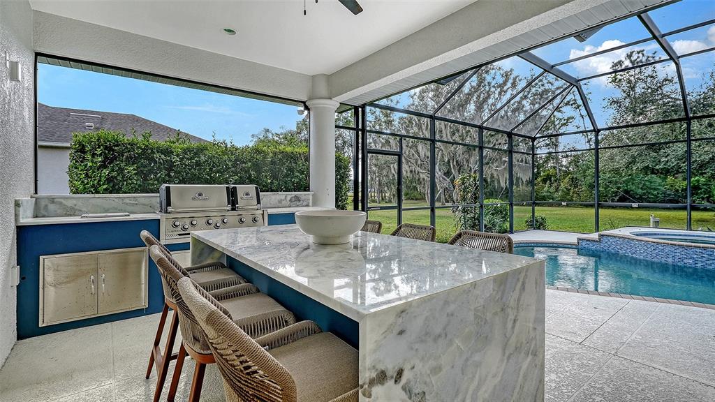 3415 162nd Avenue East Parrish, FL 34219 - Photo 38 of 49 a view of a patio with a table chairs and a backyard