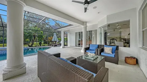 a living room with furniture and a floor to ceiling window