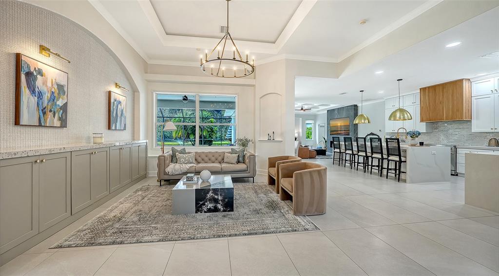 3415 162nd Avenue East Parrish, FL 34219 - Photo 4 of 49 a living room with furniture a chandelier and a dining table