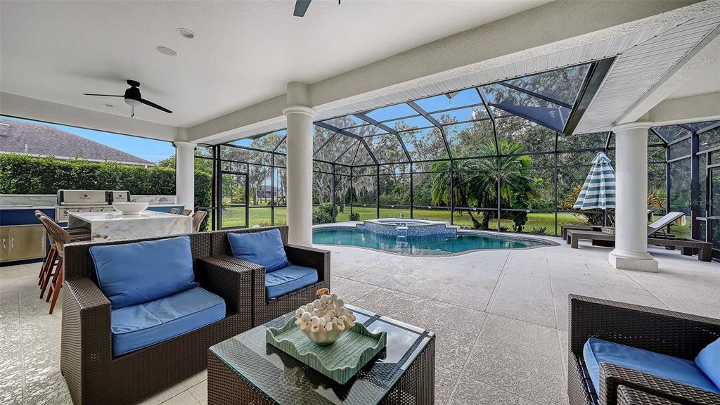 3415 162nd Avenue East Parrish, FL 34219 - Photo 41 of 49 a living room with furniture and a floor to ceiling window