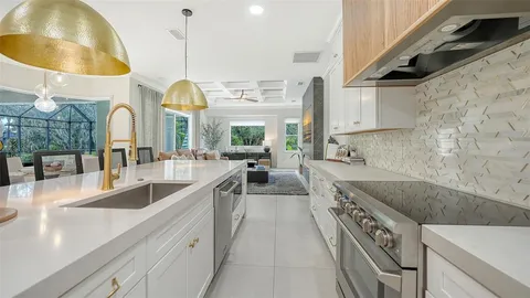 a kitchen with stainless steel appliances granite countertop a sink and a stove