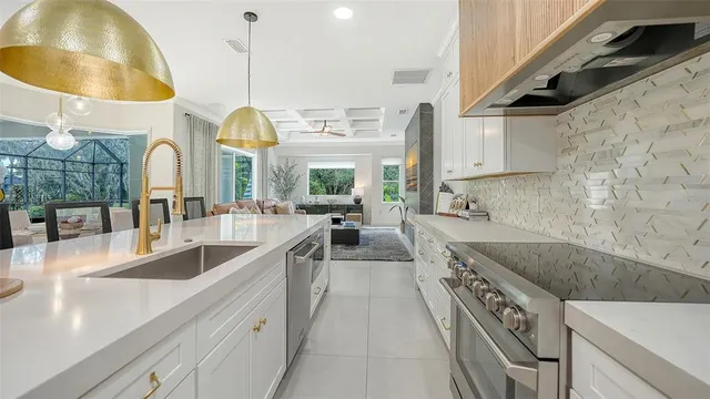 a kitchen with stainless steel appliances granite countertop a sink and a stove