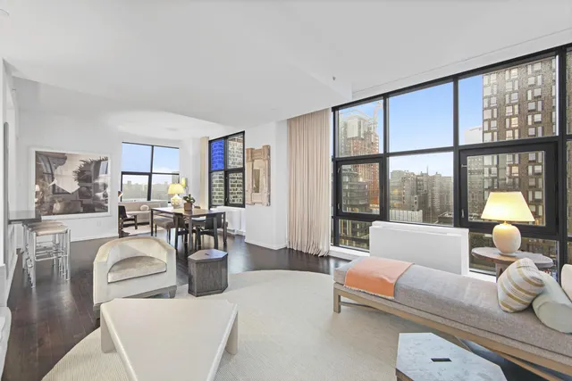 a room with lots of furniture and a large window