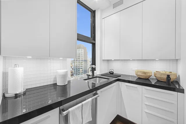a kitchen with a stove a sink and a refrigerator