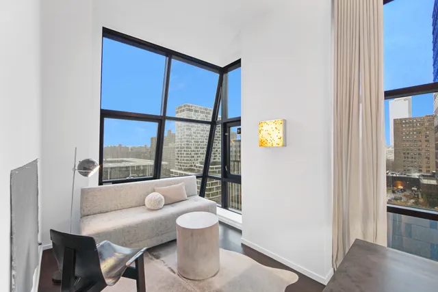 a view of a dining room with furniture large window and wooden floor