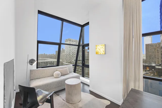 a view of a dining room with furniture large window and wooden floor
