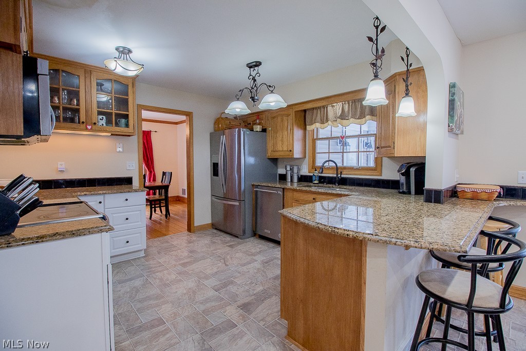 7750 Garfield Road Mentor, OH 44060 - Photo 10 of 26 Large eat-in kitchen with granite counter tops, breakfast bar, stainless steel appliances (dishwasher will not stay), and ample cabinet space, in addition to the two pantries.