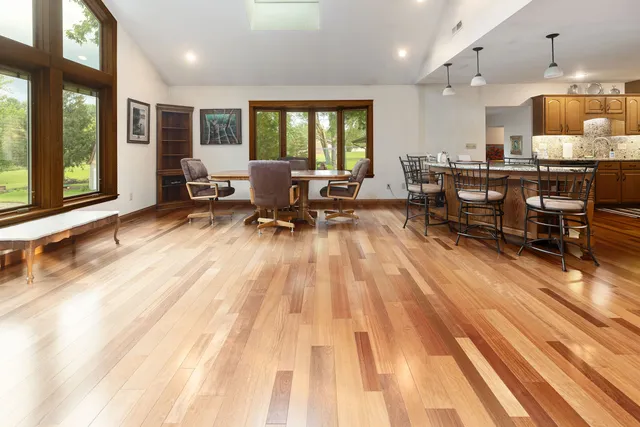 a living room filled with furniture and large windows