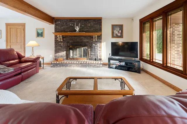 a view of livingroom with furniture and large windows