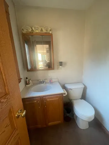 a bathroom with a toilet sink and mirror