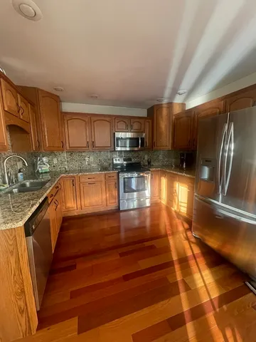 a kitchen with granite countertop a stove and cabinets