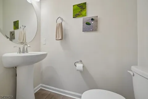 a bathroom with a sink mirror and toilet