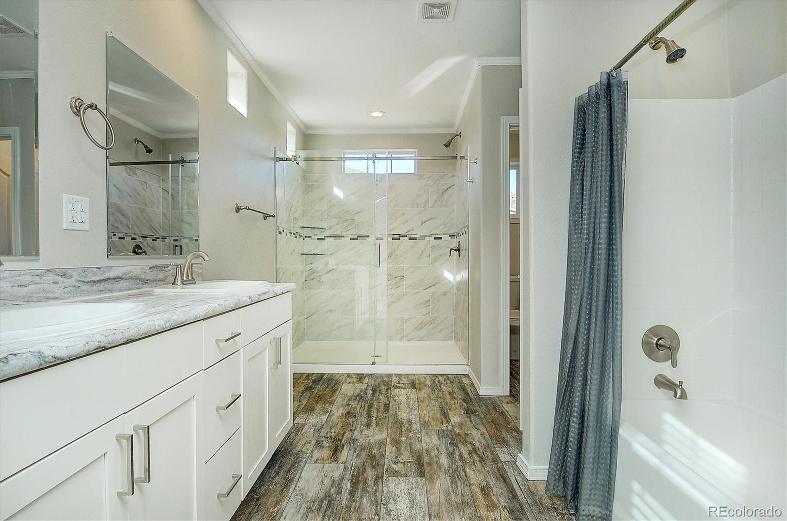 16554 Rocky Mountain Road Salida, CO 81201 - Photo 23 of 33 a bathroom with a granite countertop sink a shower and a mirror