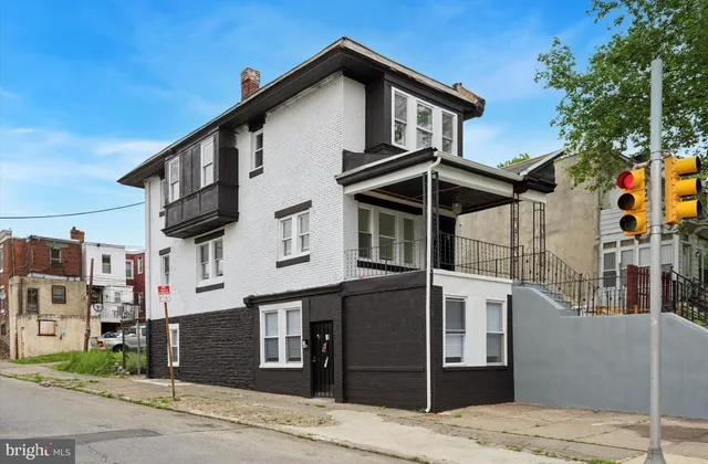 a front view of a house with a street