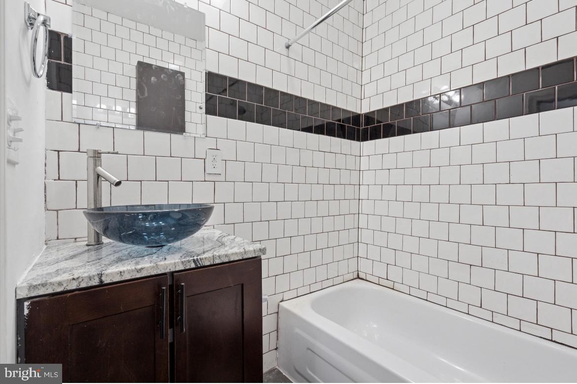 1999 Church Lane, Unit 1 Philadelphia, PA 19141 - Photo 8 of 10 a bathroom with a bathtub and shower