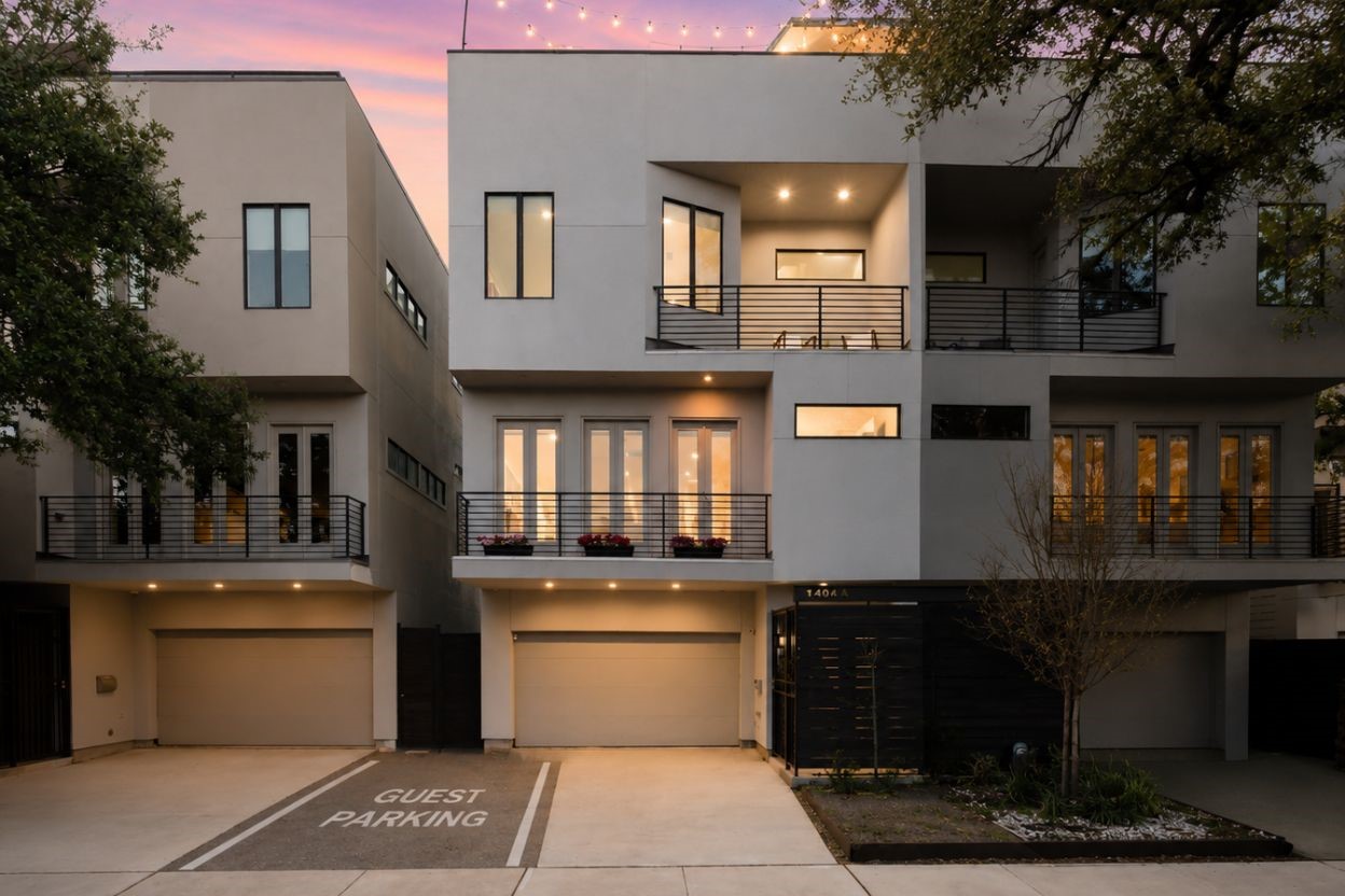 1405 Vermont Street, Unit A Houston, TX 77006 - Photo 6 of 46 Modern stucco and siding define the sophisticated exterior of 1405 Vermont Street #A, a premier three-story Bradford Mews residence. This luxury contemporary home features a private driveway leading to a two-car garage with EV charging capability. Multiple private balconies and a sprawling rooftop deck with string lighting provide exceptional outdoor living spaces minutes from Downtown, Memorial Park, and the Medical Center. Expansive windows and sleek architectural lines showcase a low-maintenance lifestyl
