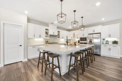 a large kitchen with stainless steel appliances granite countertop a lot of counter space