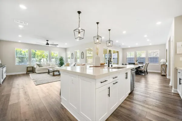 a living room with furniture and view of kitchen