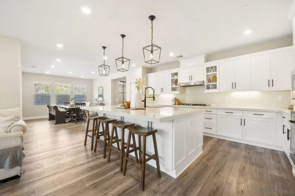a living room with stainless steel appliances kitchen island furniture and a view of kitchen