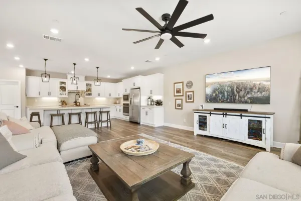 a bathroom with a granite countertop sink a toilet and a mirror