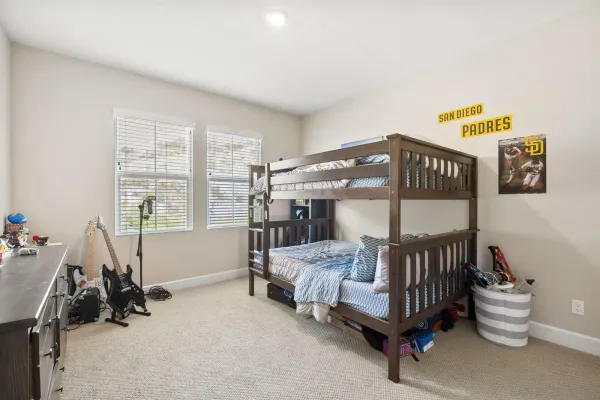 a spacious bedroom with a bed couch and window