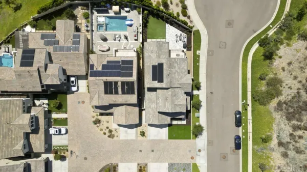an aerial view of residential houses with a city view