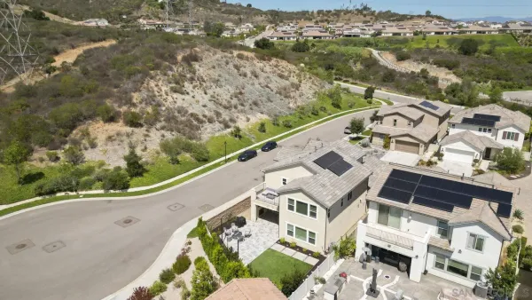 an aerial view of a house with a mountain