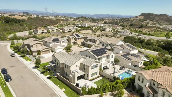 an aerial view of residential houses with outdoor space