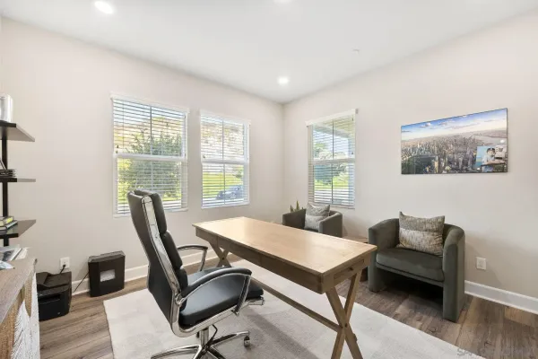 a dining room with furniture window and wooden floor