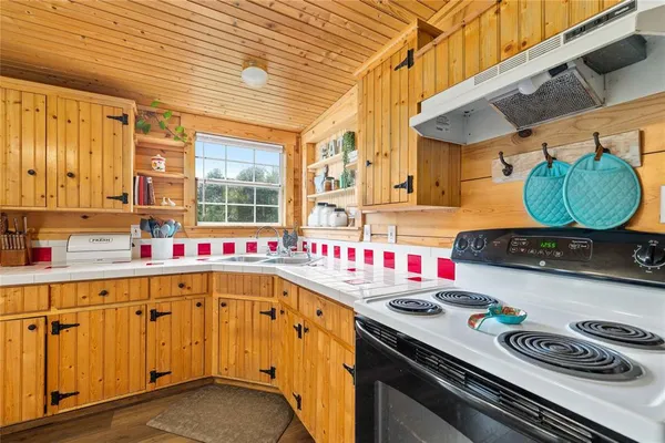 a kitchen with a sink stove and cabinets