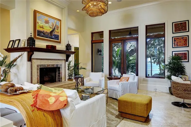 a living room with furniture ceiling fan and a large window