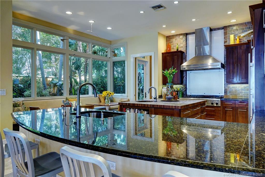 31 North River Road Stuart, FL 34996 - Photo 18 of 91 a kitchen with stainless steel appliances granite countertop a stove and a sink