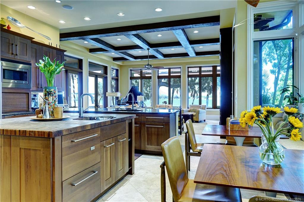 31 North River Road Stuart, FL 34996 - Photo 25 of 91 a open kitchen with stainless steel appliances granite countertop a table chairs and a large window