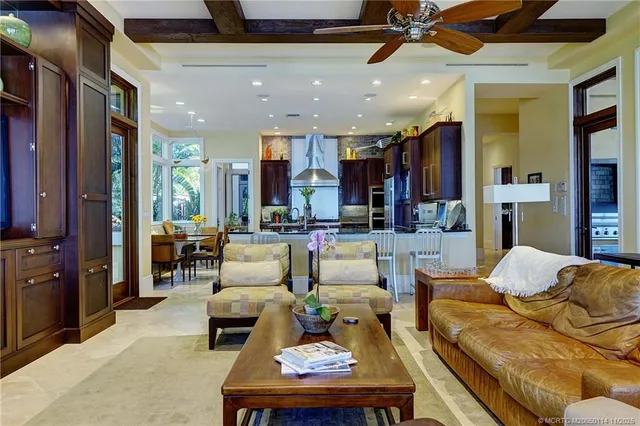 an aerial view of ocean and residential houses with outdoor space