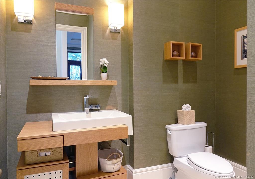 31 North River Road Stuart, FL 34996 - Photo 31 of 91 a bathroom with a sink a toilet and mirror