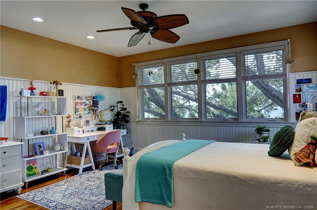 31 North River Road Stuart, FL 34996 - Photo 56 of 91 a bedroom with a bed a chandelier and a large window