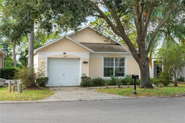 a house that has a tree in front of it