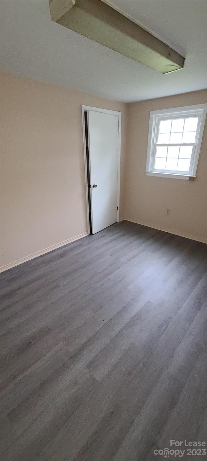 151 Crescent Drive Forest City, NC 28043 - Photo 6 of 6 an empty room with wooden floor and windows
