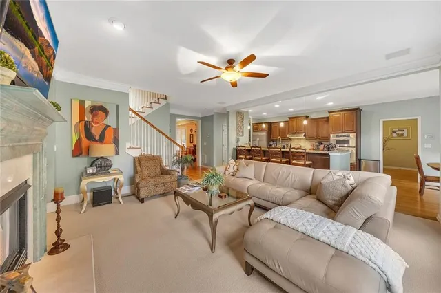 a dining room with furniture a chandelier and wooden floor