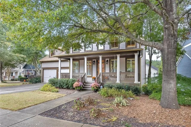a front view of a house with garden and porch