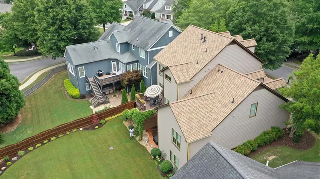 an aerial view of a house with a garden and large trees