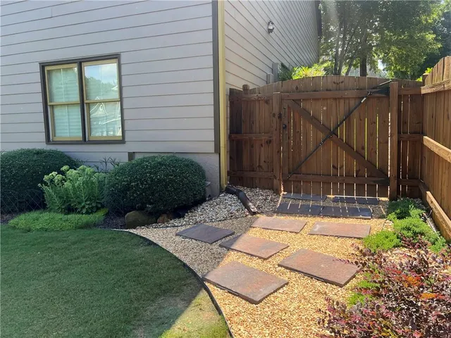 an aerial view of a house with garden space and street view