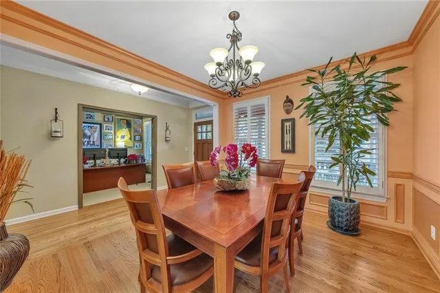 a living room with furniture kitchen view and a chandelier