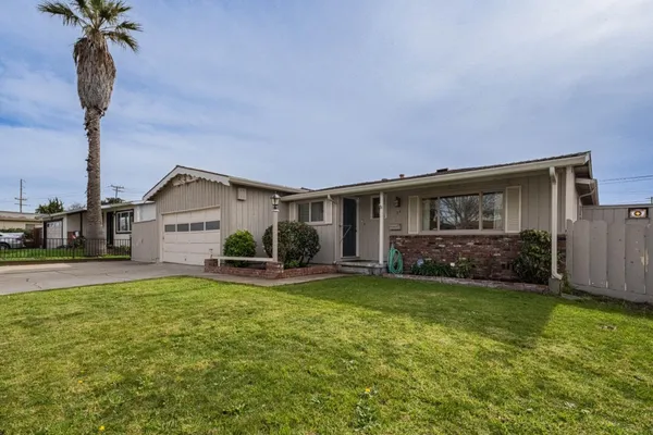 a view of a house with a yard and garage
