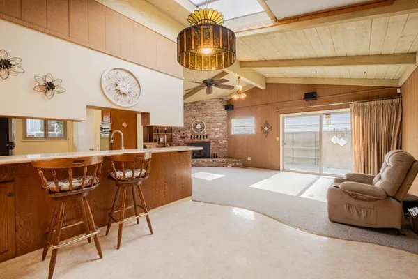 a living room with furniture a clock and a window