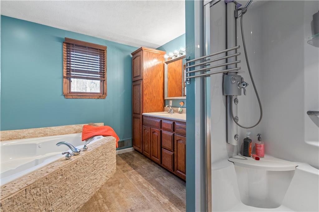 282 Snowden Road Hookstown, PA 15050 - Photo 17 of 25 a bathroom with a tub sink and mirror